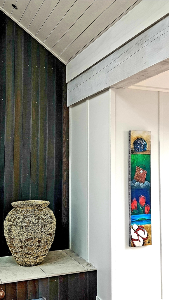 Contrasting timbers and stains in interior of bach by Whelan Building on Waiheke Island